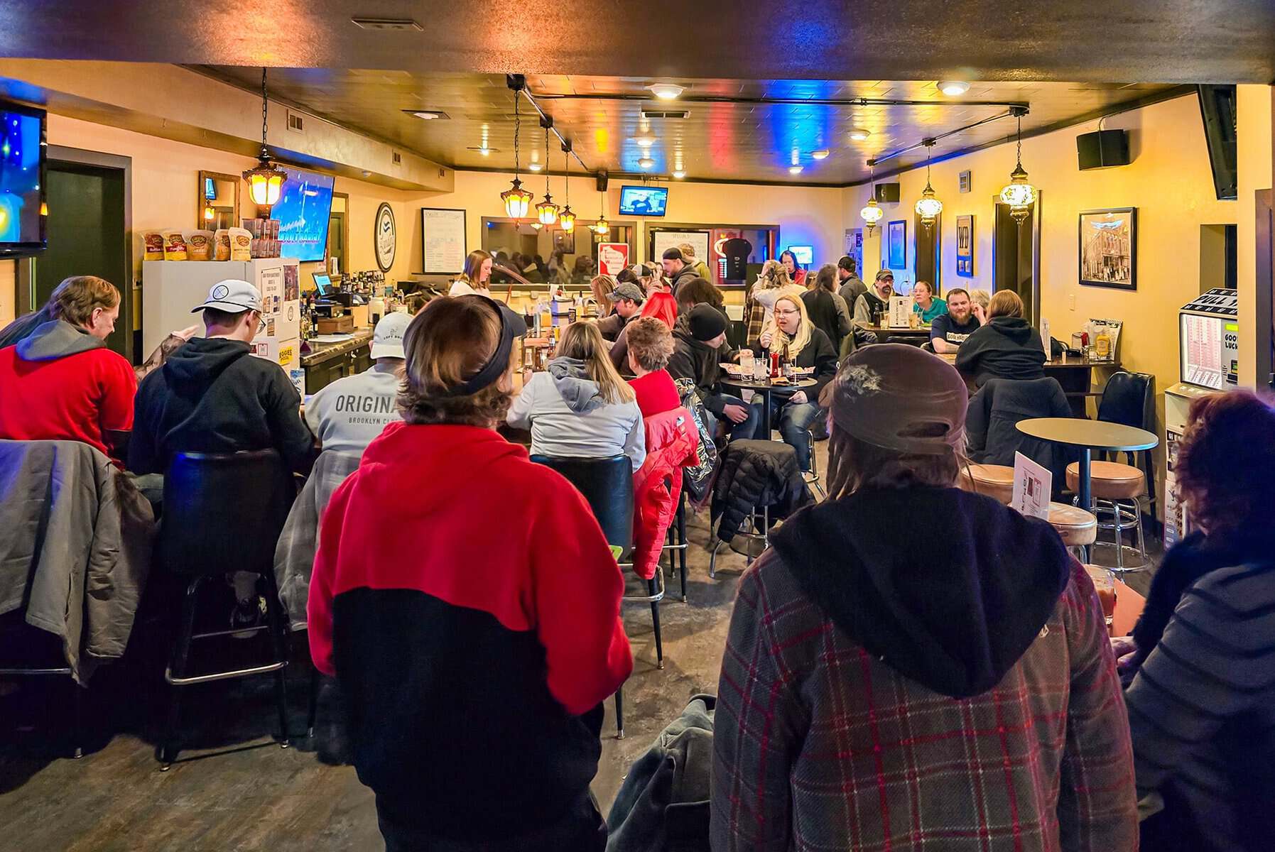 Guests Dining And Sitting At The Bar